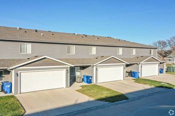 a home with two garages and a street in front of it  at Beal Townhomes, Sioux Falls, SD